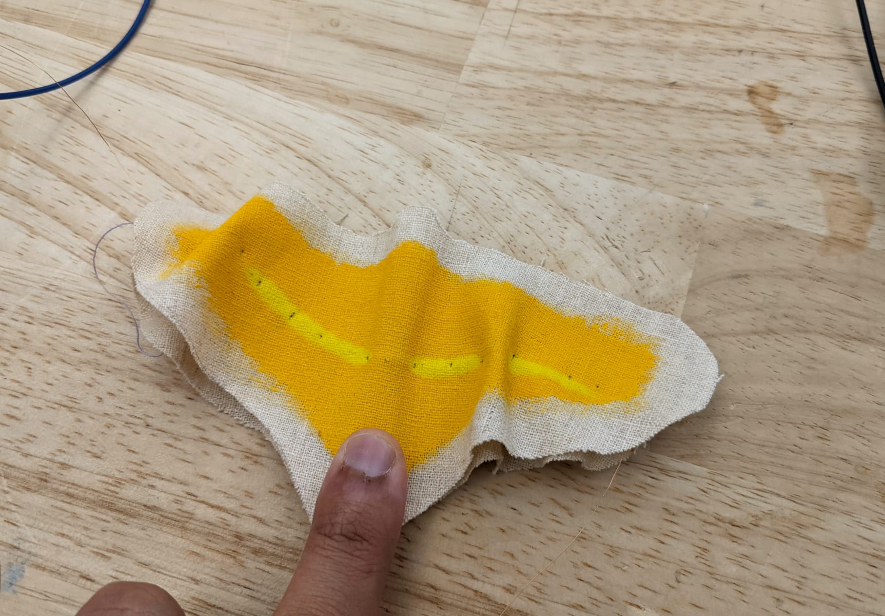 finger touching the copper tape at the bottom and the wings folding in with the colour turning a ligher shade of yellow