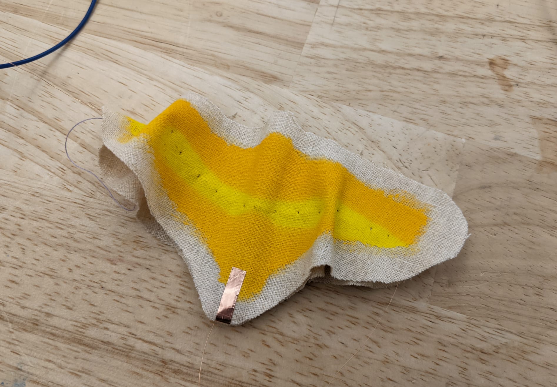 finger no longer on the copper tape, and the lighter shade of yellow spreading and more pronounced