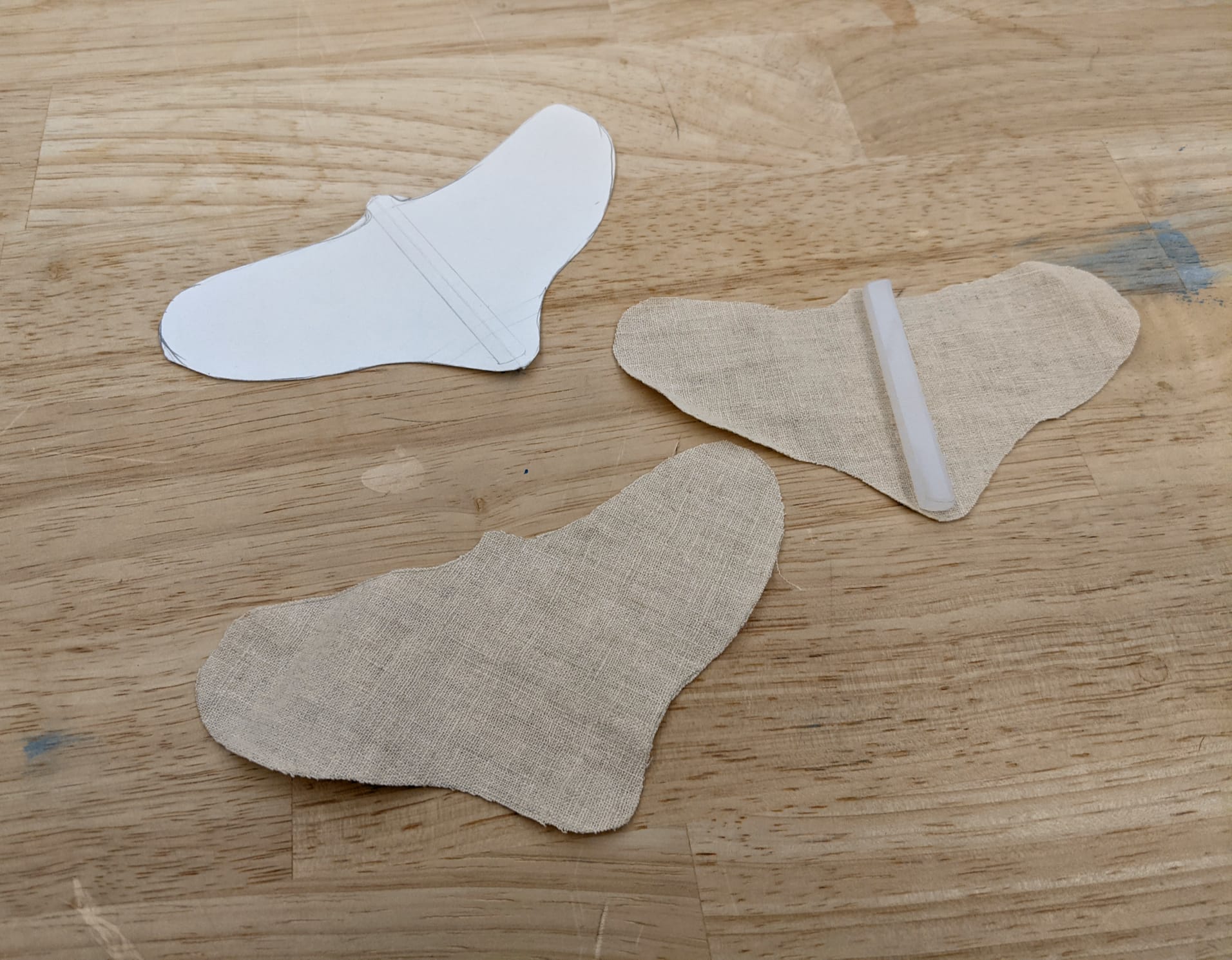 using a paper stencil to draw a moth shape