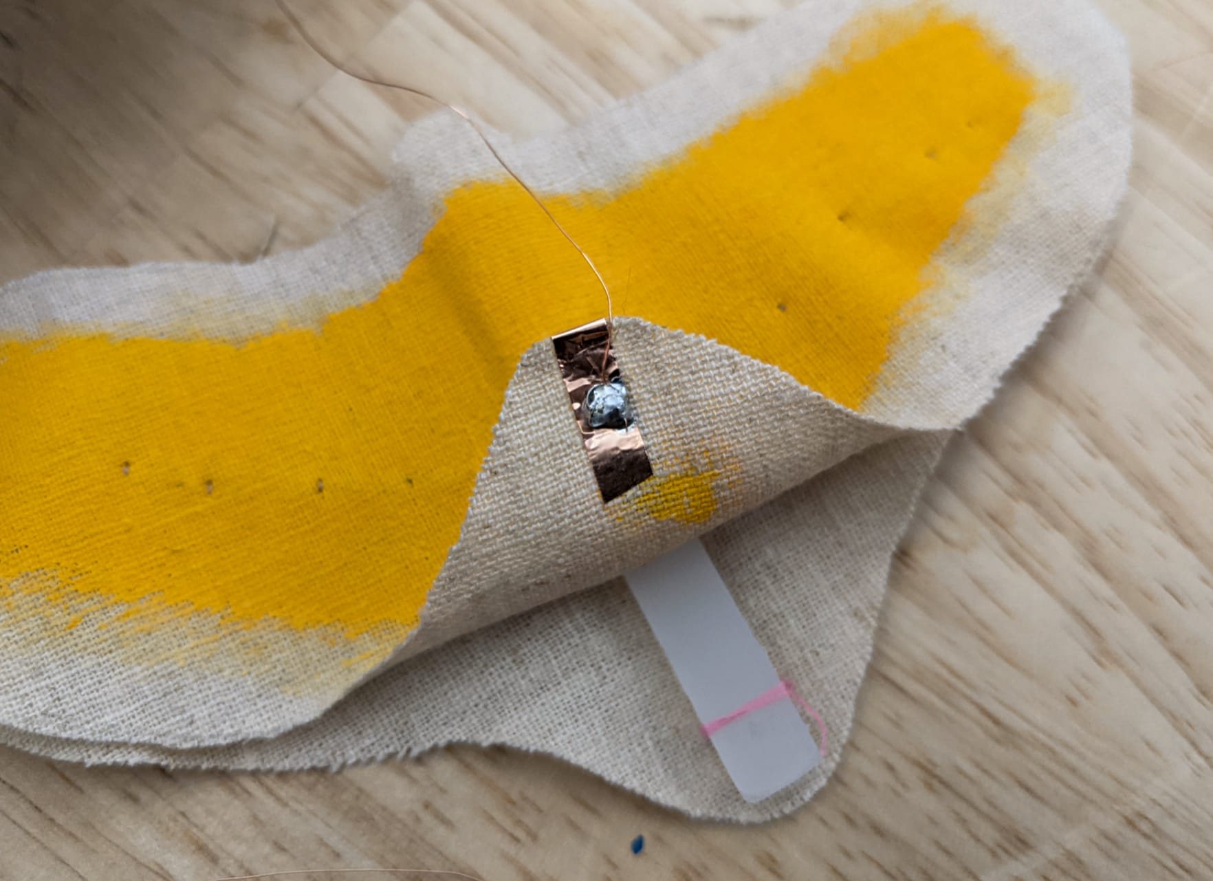 underside of copper tape of the top layer, with solder connecting it to copper wire