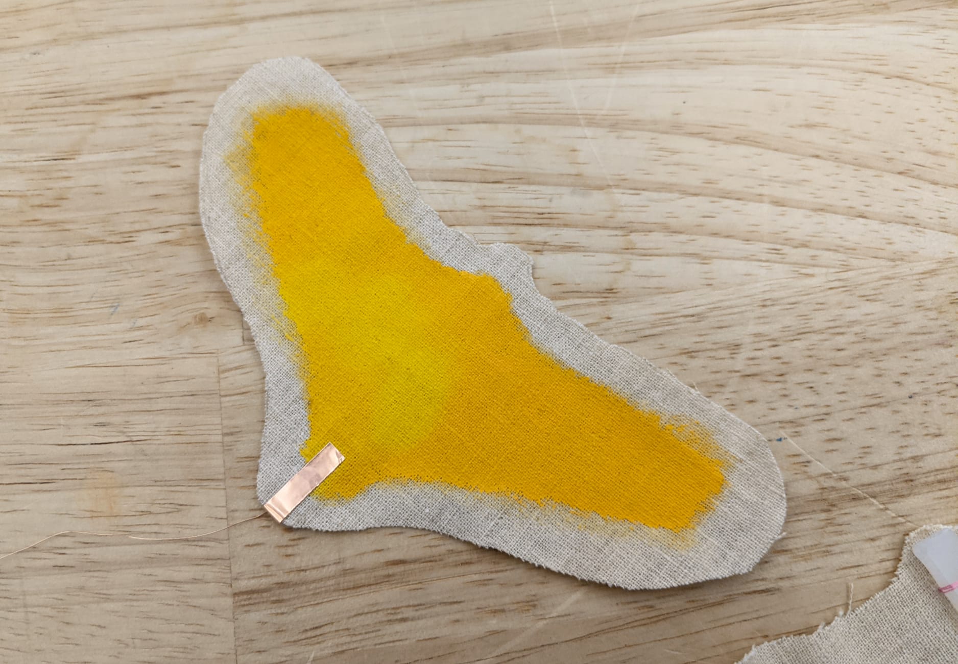 Yellow thermochromic dye on top layer and copper tape at the bottom